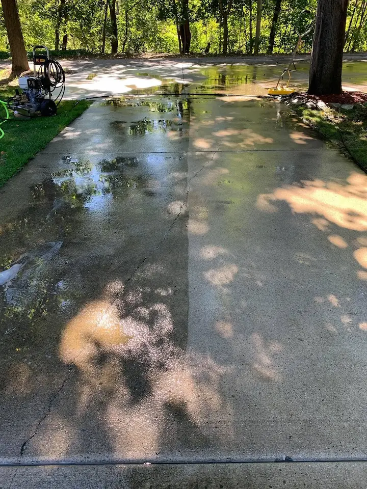 A driveway that has been halfway pressure washed