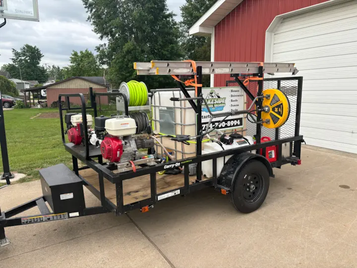 A branded trailer with pressure washing equipment