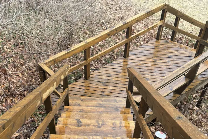 Pressure washing wooden porch.