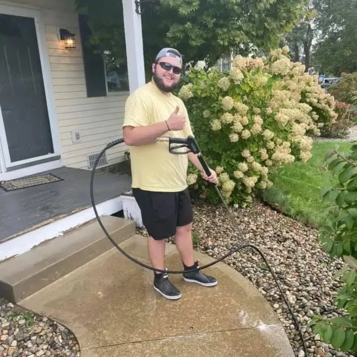 A curb being pressure washed